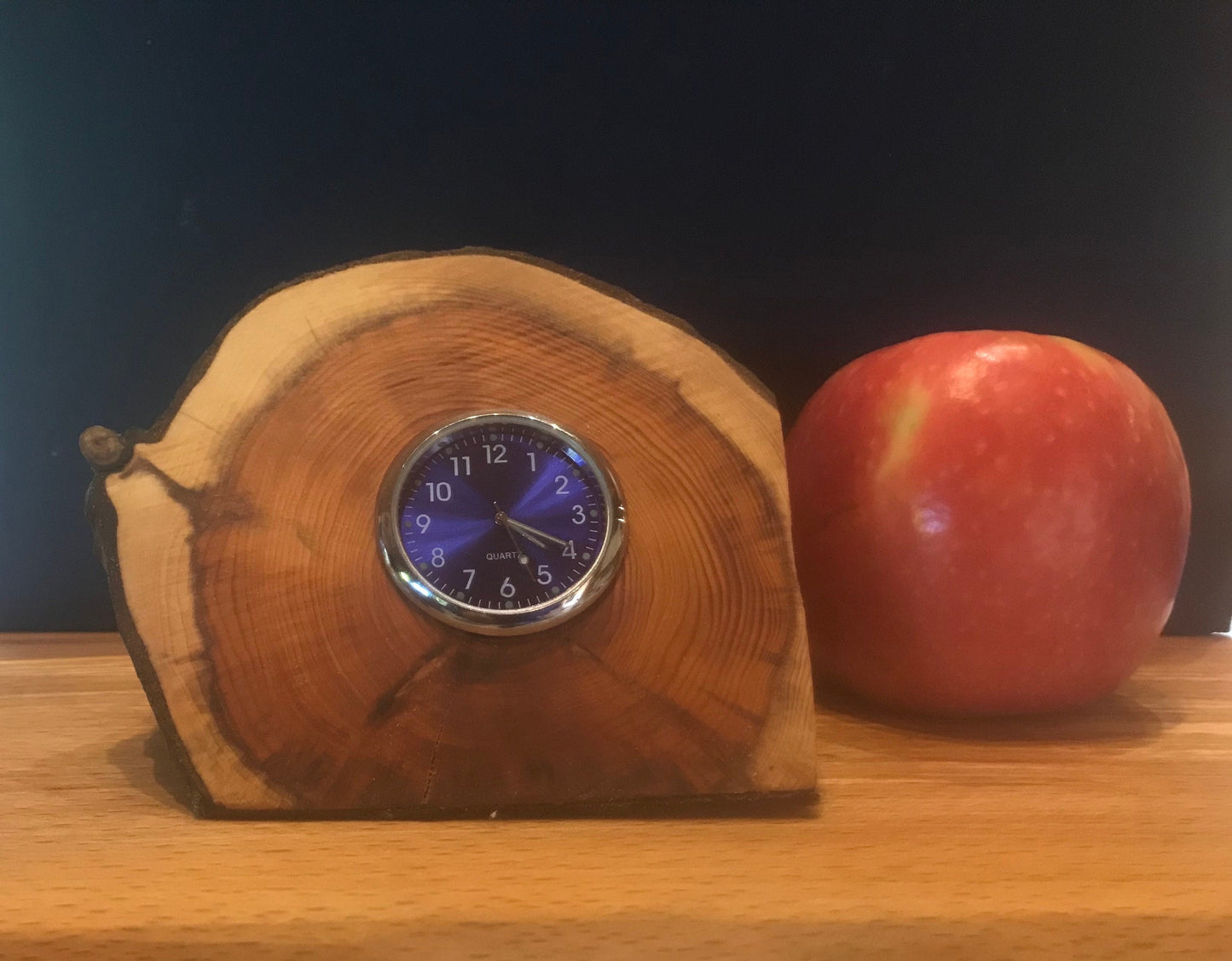 Handmade miniature clock in yew in unique design. There is a choice of 8 clock face colours