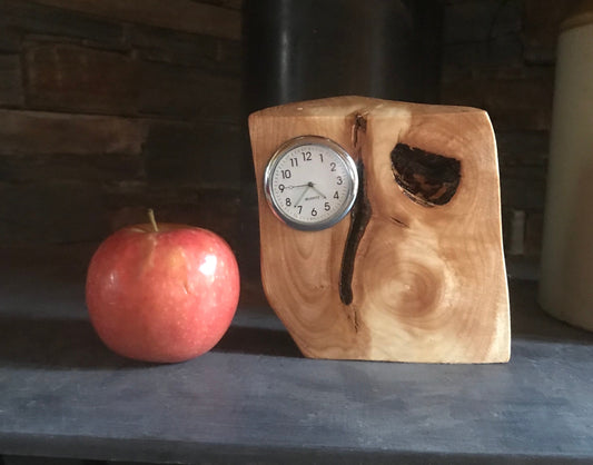 Handmade miniature clock in yew in unique design. There is a choice of 8 different clock face colours