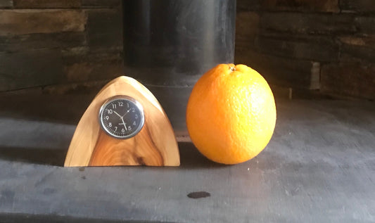 Handmade miniature clock in yew in unique design. There is a choice of two different clock face colours